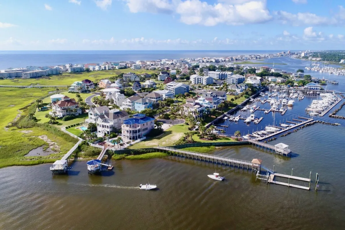 A vibrant marina scene with anchored boats, lush greenery, spacious waterfront properties, and a residential community. The atmosphere is lively, with an emphasis on boating, fishing, and waterside activities.