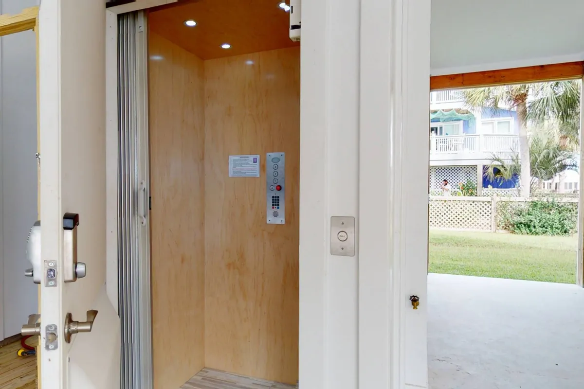 A view of the modern elevator interior, complete with a clear control panel and wide doorway for accessibility. The design is sleek and the elevator is well-lit, making it easy to envision guests using it for convenience on every floor.